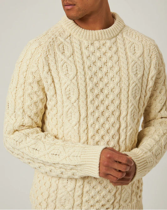 Close view of the ecru Peregrine Hudson Aran Jumper showing its cable-knit British wool texture.